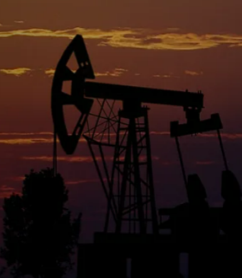 Oil pump jack silhouette at sunset